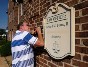 Mark Hackley, President Augusta Sign Company, takes down a sign he made to repair, Friday, September 9, 2016. (Photo by Norm Shafer).