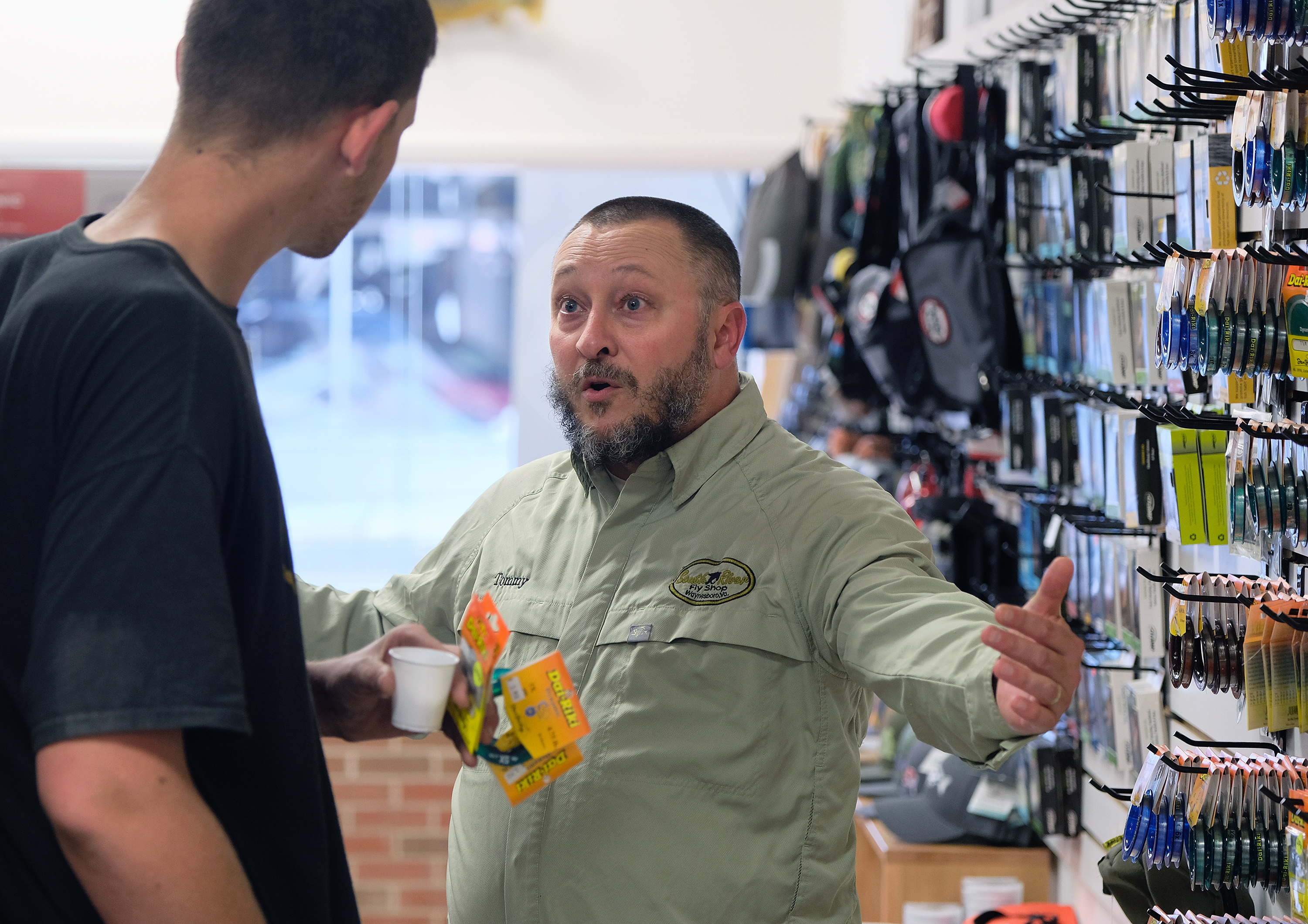 Tommy Lawhorne, right, talks with customer Chase Halterman of Goshen, Va. at the South River Fly shop in Waynesboro, Va., Thursday, Oct. 13, 2016. (Photo by Norm Shafer).