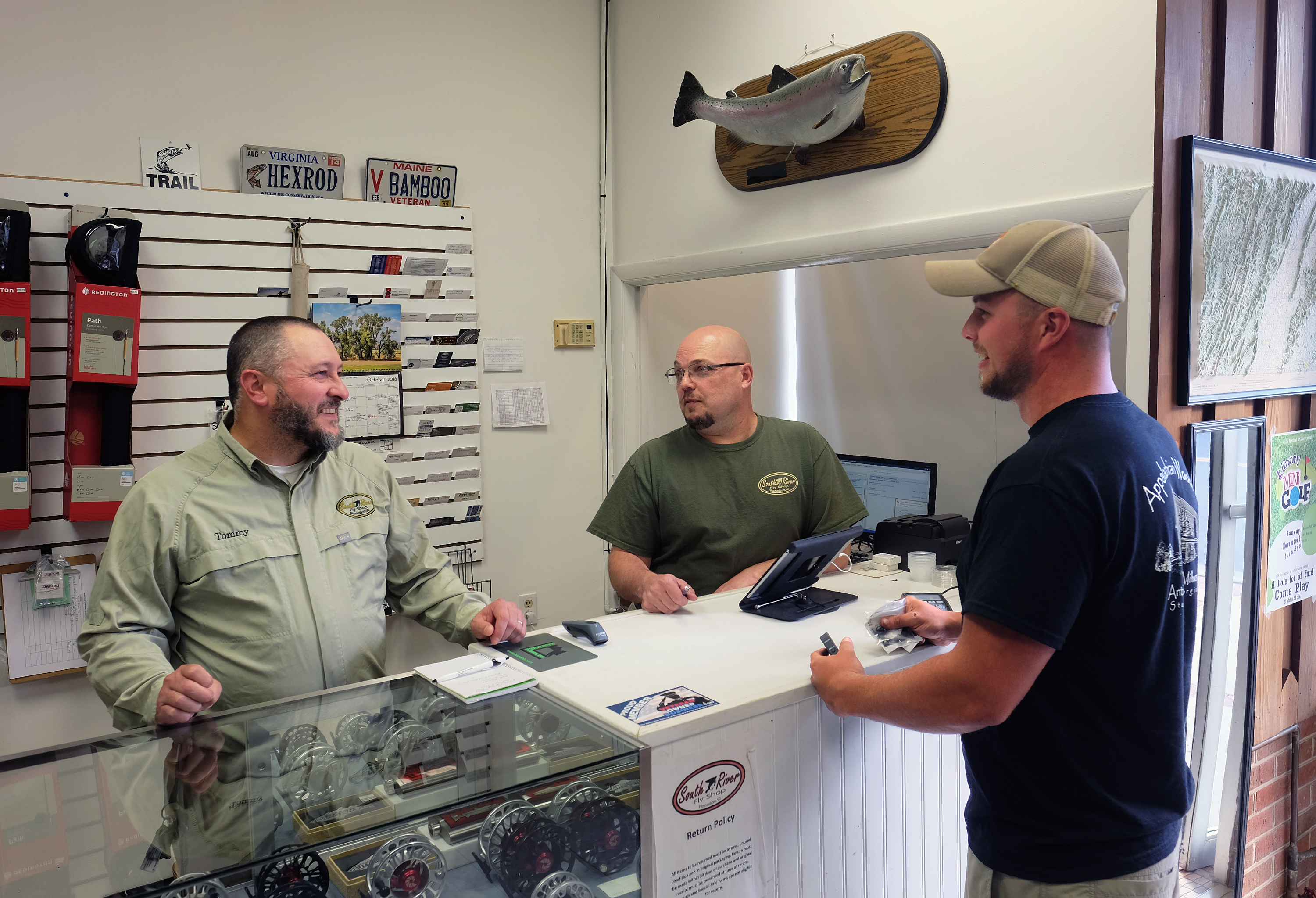 Tommy Lawhorne, and Kevin Little talk with customer Will Walter of Doom, Va. at the South River Fly shop in Waynesboro, Va., Thursday, Oct. 13, 2016. (Photo by Norm Shafer).