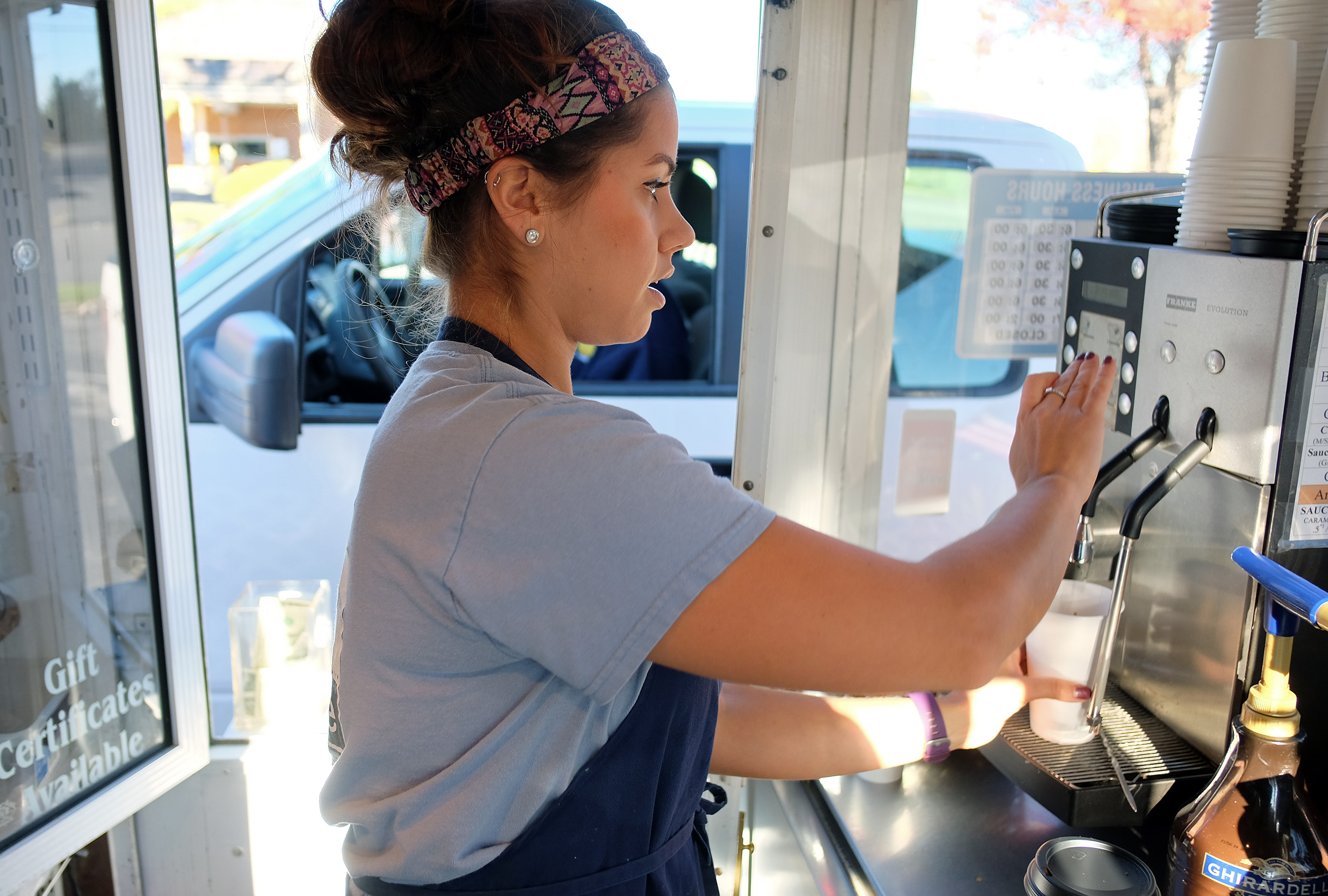 Kelsey Shreckhise, manager of Micah's Coffee helps a customer in Waynesboro, Va. Thursday Nov. 10, 2016. (Photo by Norm Shafer).