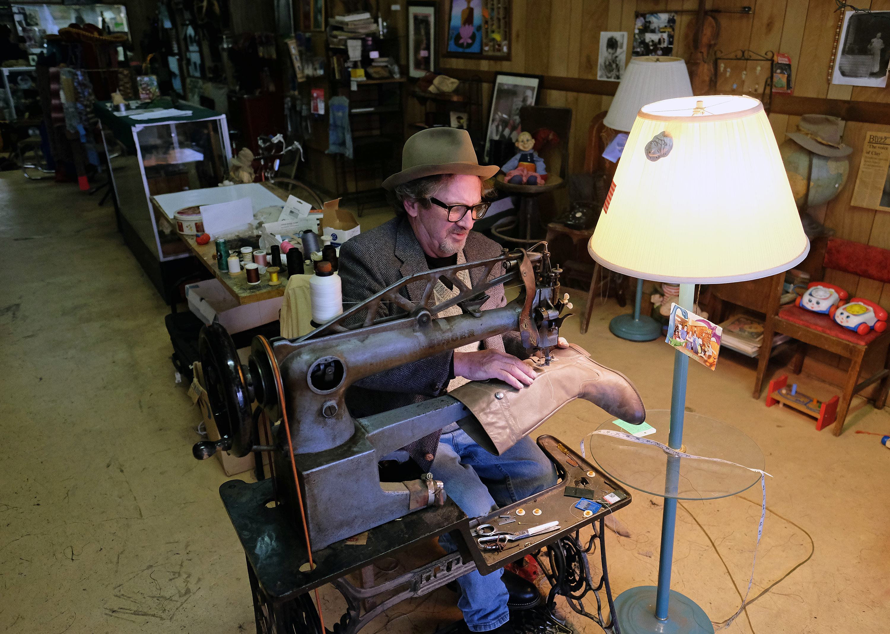 David Young sews a boot on an old Singer treadle sewing machine,Wednesday Nov. 23, 2016. (Photo by Norm Shafer).